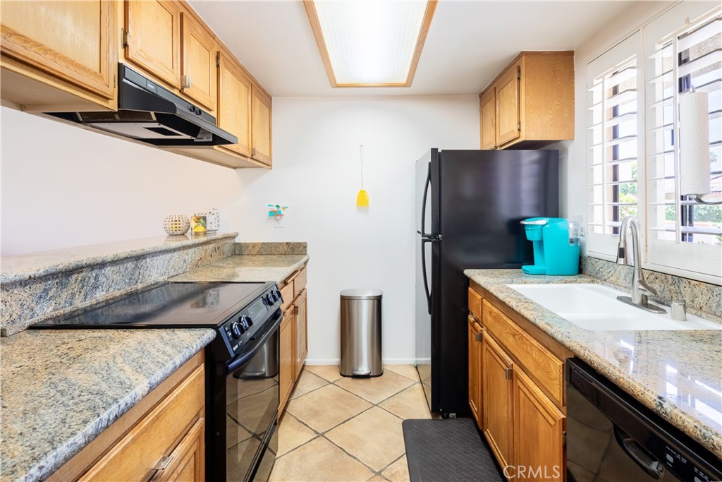 40657 Preston Trail Palm Desert, CA 92211 - Photo 25 of 46 a kitchen with stainless steel appliances granite countertop a sink a stove and refrigerator