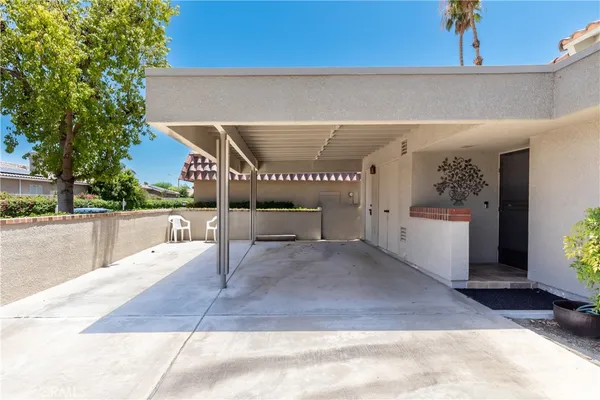 a view of a patio with chairs and a yard