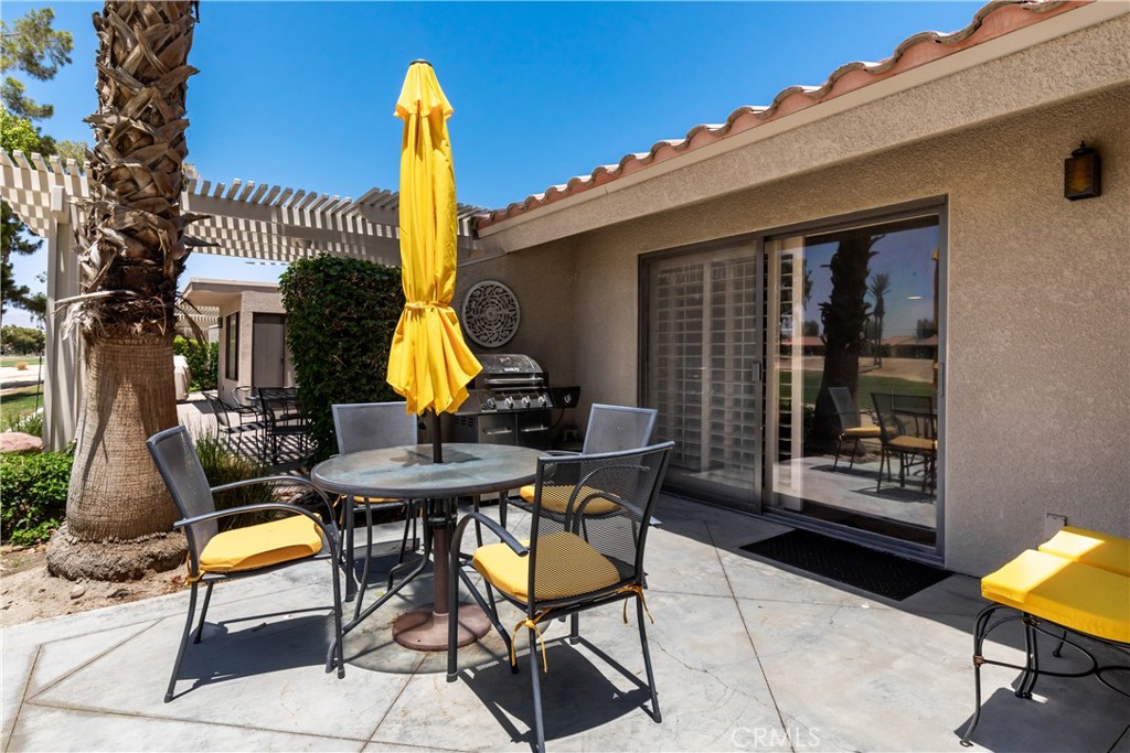 40657 Preston Trail Palm Desert, CA 92211 - Photo 41 of 46 a view of a patio with a table and chairs