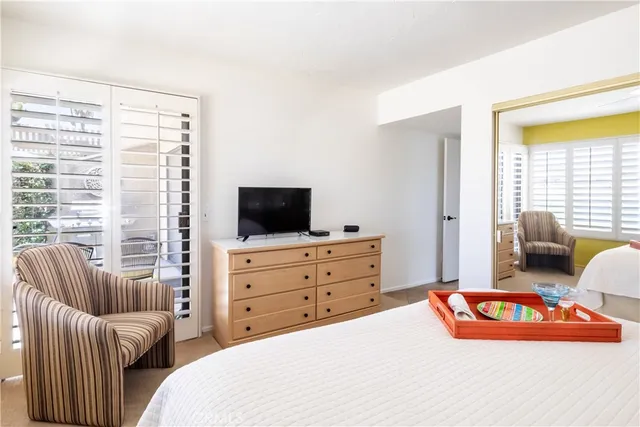 a bedroom with furniture and a flat screen tv