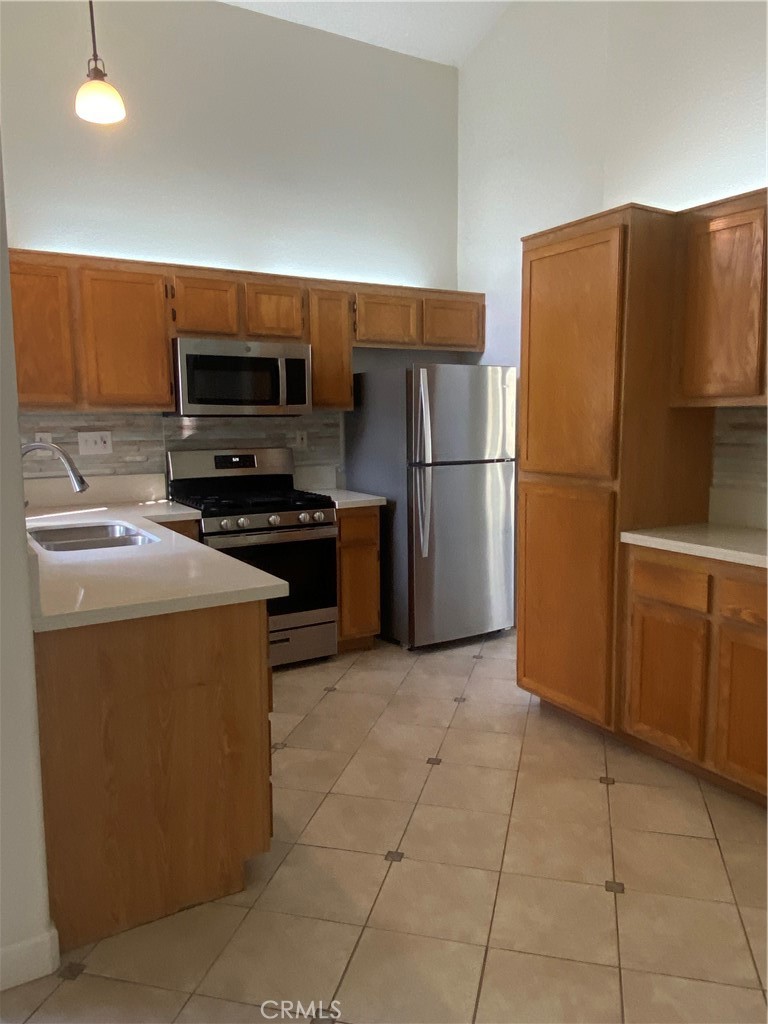3301 Orangewood Irvine, CA 92618 - Photo 5 of 10 a kitchen with stainless steel appliances granite countertop a refrigerator and a stove top oven