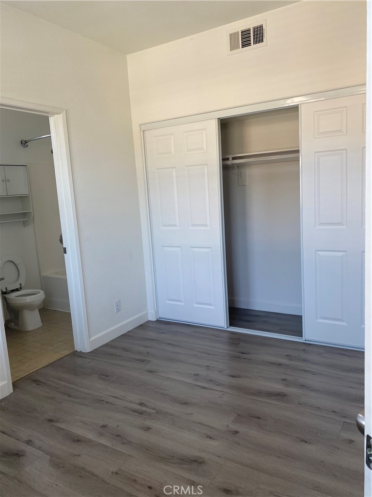3301 Orangewood Irvine, CA 92618 - Photo 6 of 10 a view of an empty room with wooden floor and a window