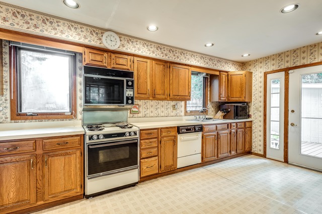 191 Lawton Road Riverside, IL 60546 - Photo 11 of 25 a kitchen with granite countertop a stove top oven sink and cabinets