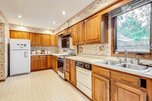 191 Lawton Road Riverside, IL 60546 - Photo 10 of 25 a kitchen with a sink appliances cabinets and a large window