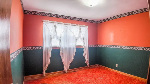 a view of a room with sliding door and wooden floor