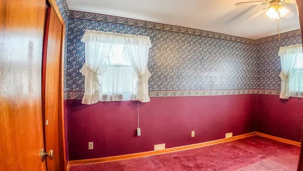 a view of a room with wooden walls and sliding window