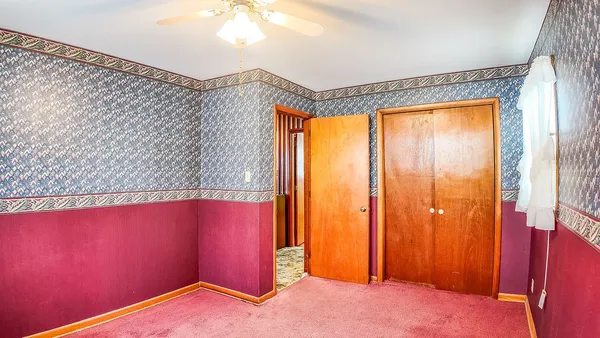 a view of empty room with window and air conditioner