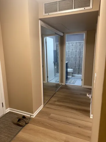 a view of a dining room with furniture and a chandelier
