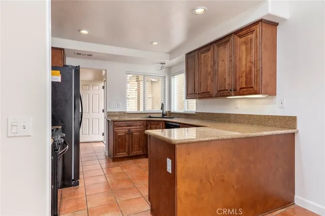 a kitchen with a refrigerator a sink and a stove top oven