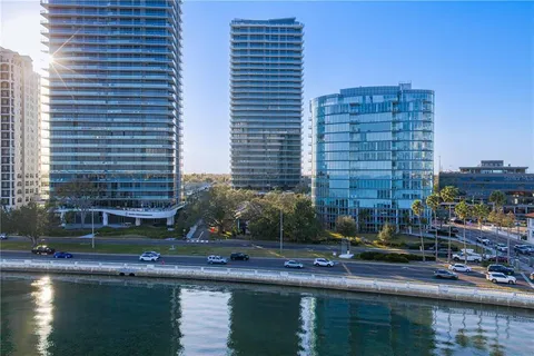 a front view of a building with lake view and a yard