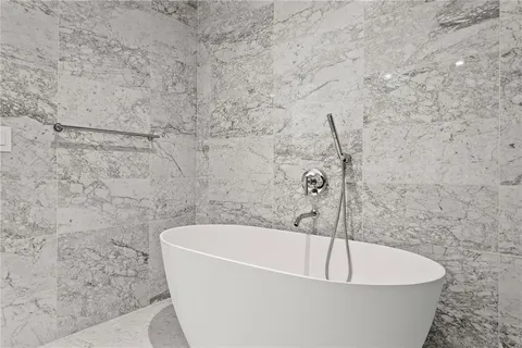 a white bath tub sitting in a bathroom