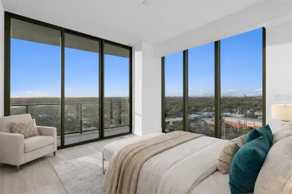 a bedroom with a large bed and a large window