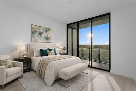 a bedroom with a large bed and a large window