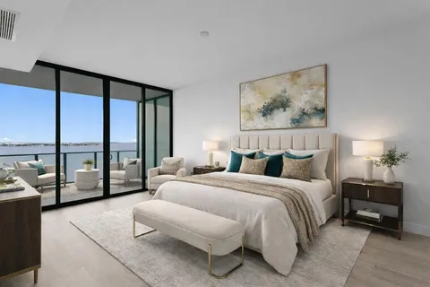 a bedroom with a bed and a large window