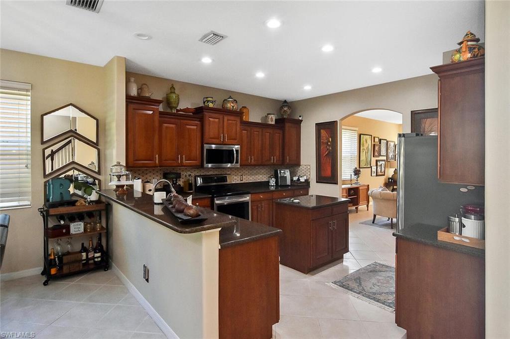 12421 Rock Ridge Lane Fort Myers, FL 33913 - Photo 12 of 50 a kitchen with a sink and cabinets