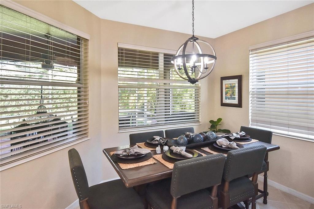 12421 Rock Ridge Lane Fort Myers, FL 33913 - Photo 14 of 50 a view of a dining room with furniture wooden floor and a chandelier