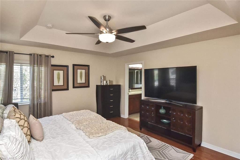 12421 Rock Ridge Lane Fort Myers, FL 33913 - Photo 24 of 50 a bedroom with a bed and a flat screen tv