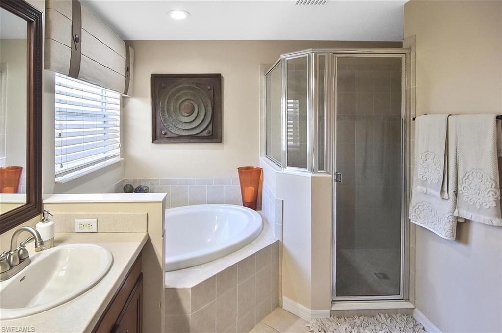 12421 Rock Ridge Lane Fort Myers, FL 33913 - Photo 26 of 50 a bathroom with a sink a bathtub and a shower