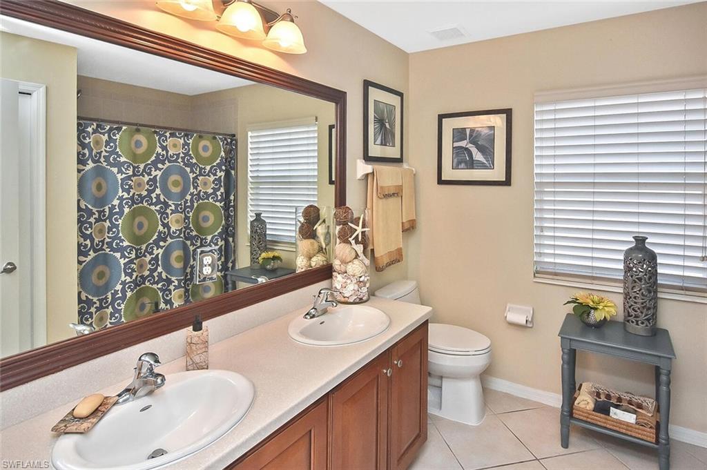 12421 Rock Ridge Lane Fort Myers, FL 33913 - Photo 30 of 50 a bathroom with a toilet sink and mirror