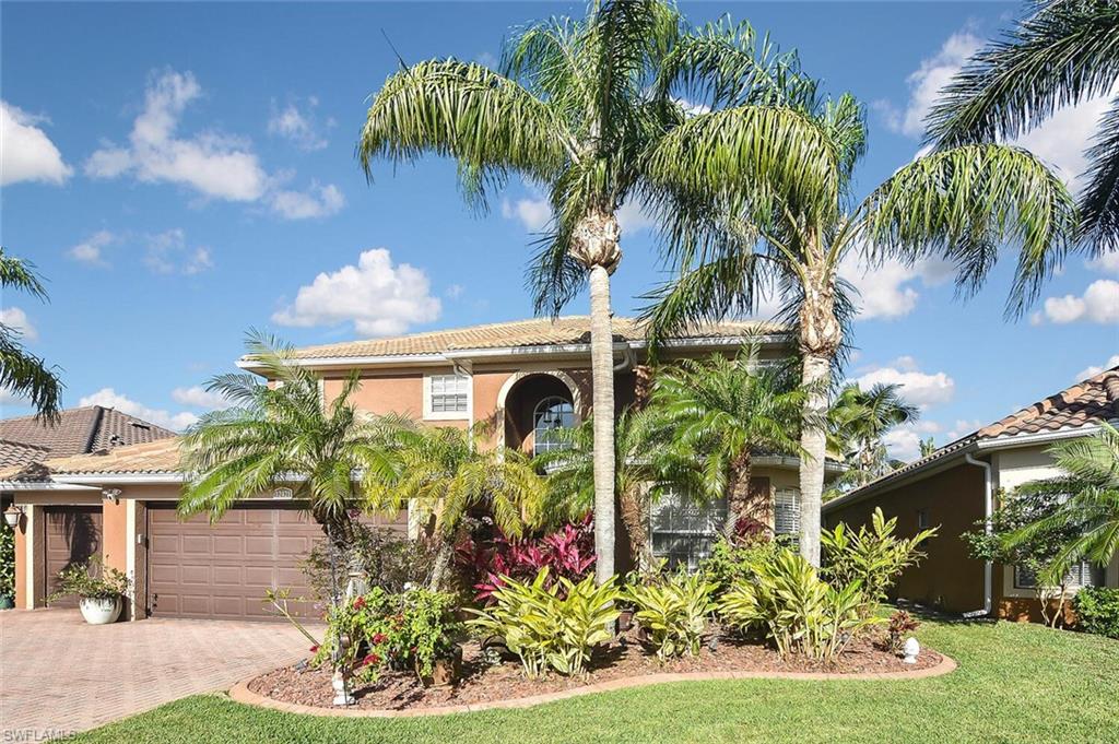 12421 Rock Ridge Lane Fort Myers, FL 33913 - Photo 48 of 50 a front view of a house with a yard and a garden