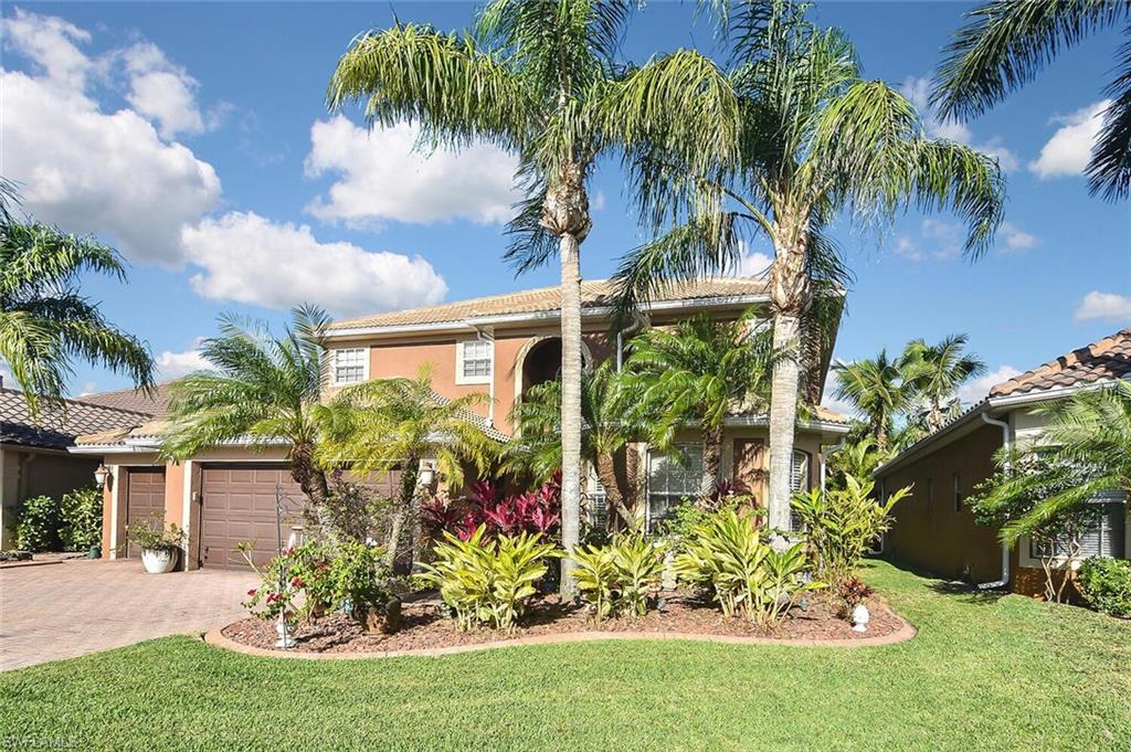 12421 Rock Ridge Lane Fort Myers, FL 33913 - Photo 49 of 50 a front view of a house with a garden and entryway