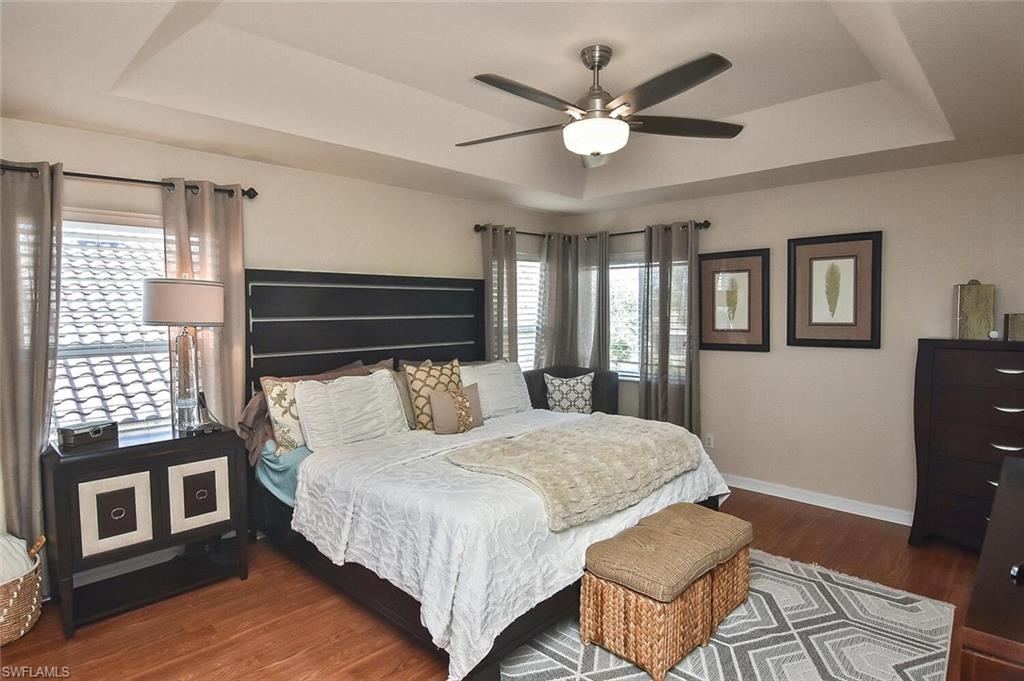 12421 Rock Ridge Lane Fort Myers, FL 33913 - Photo 6 of 50 a bedroom with a large bed chandelier and a window