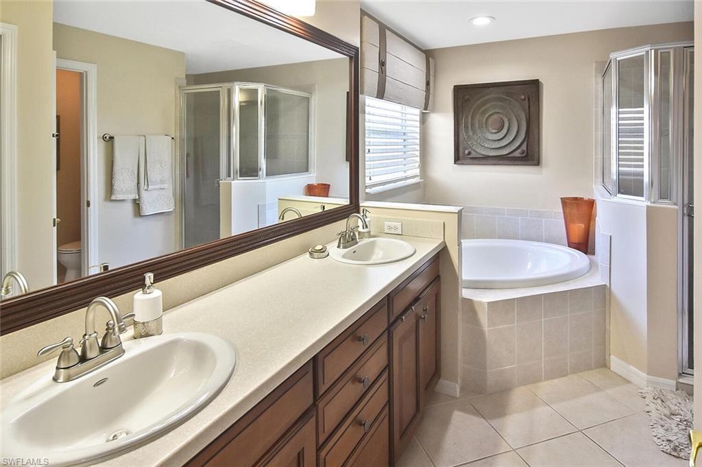 12421 Rock Ridge Lane Fort Myers, FL 33913 - Photo 7 of 50 a bathroom with a sink double vanity and a mirror