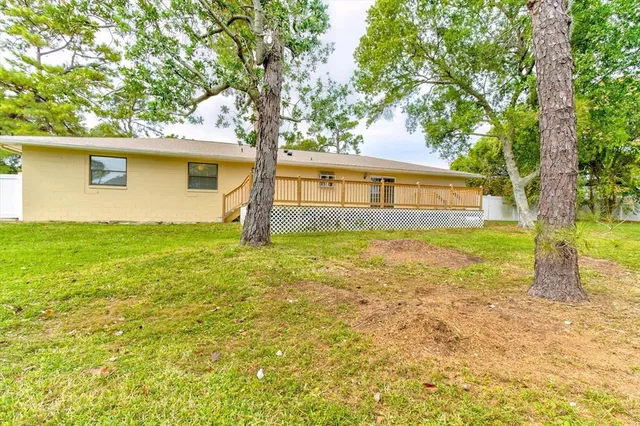 an aerial view of a house with a yard basket ball court and outdoor seating