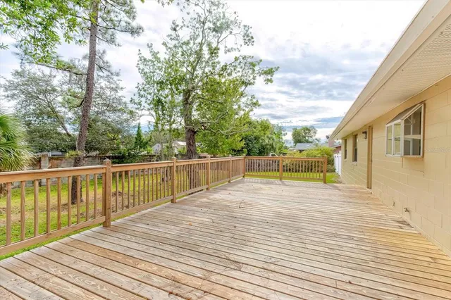 a view of a yard with plants and trees