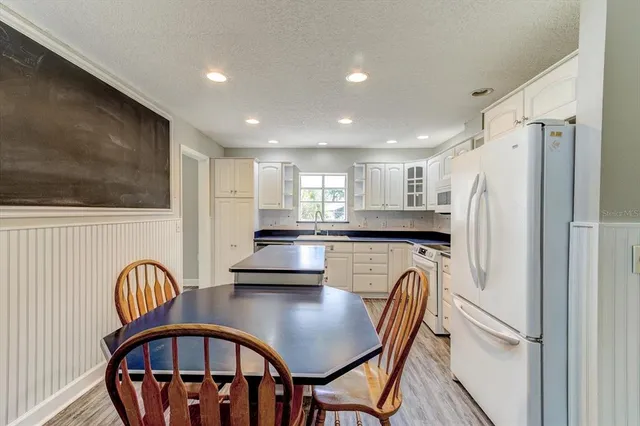 a view of a dining room with furniture and a chandelier