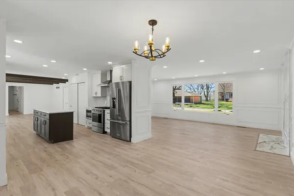 a view of a kitchen with a refrigerator and a microwave