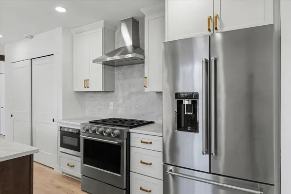 a kitchen with stainless steel appliances a refrigerator and a stove