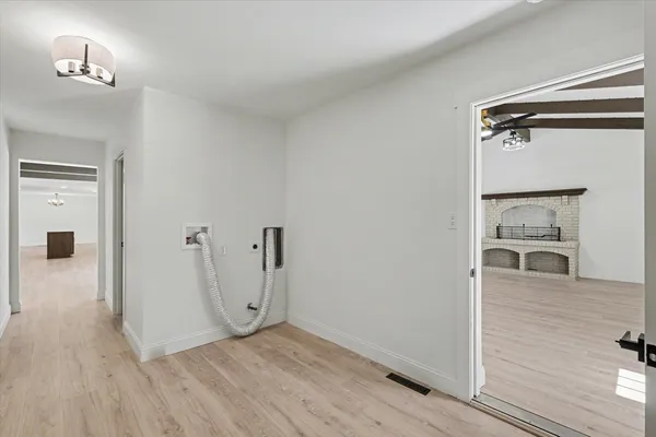 a view of a room with wooden floor