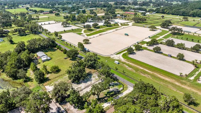 an aerial view of residential houses with outdoor space and swimming pool