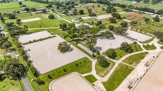 an aerial view of residential houses with outdoor space and swimming pool