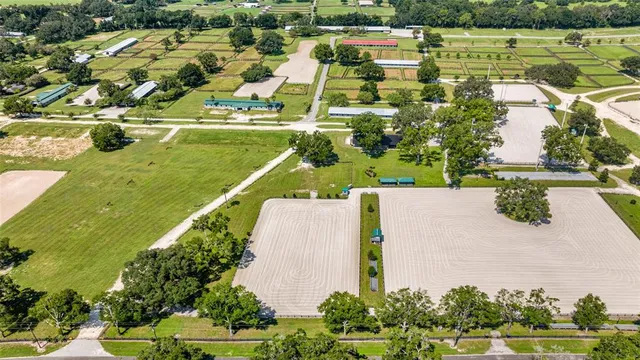 an aerial view of a houses with a yard