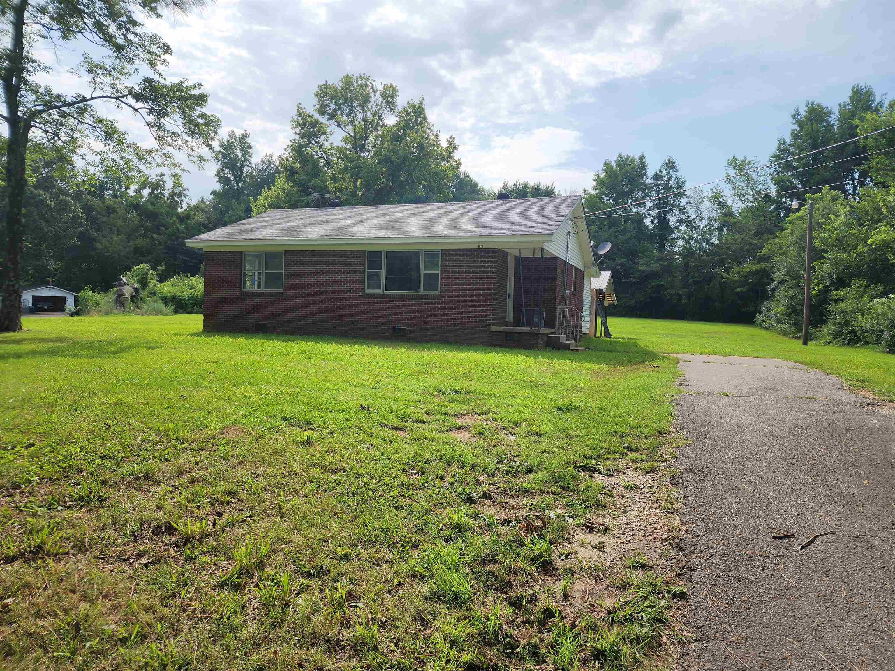 6673 Highway 209 Ripley, TN 38063 - Photo 1 of 13 a view of a house with a yard