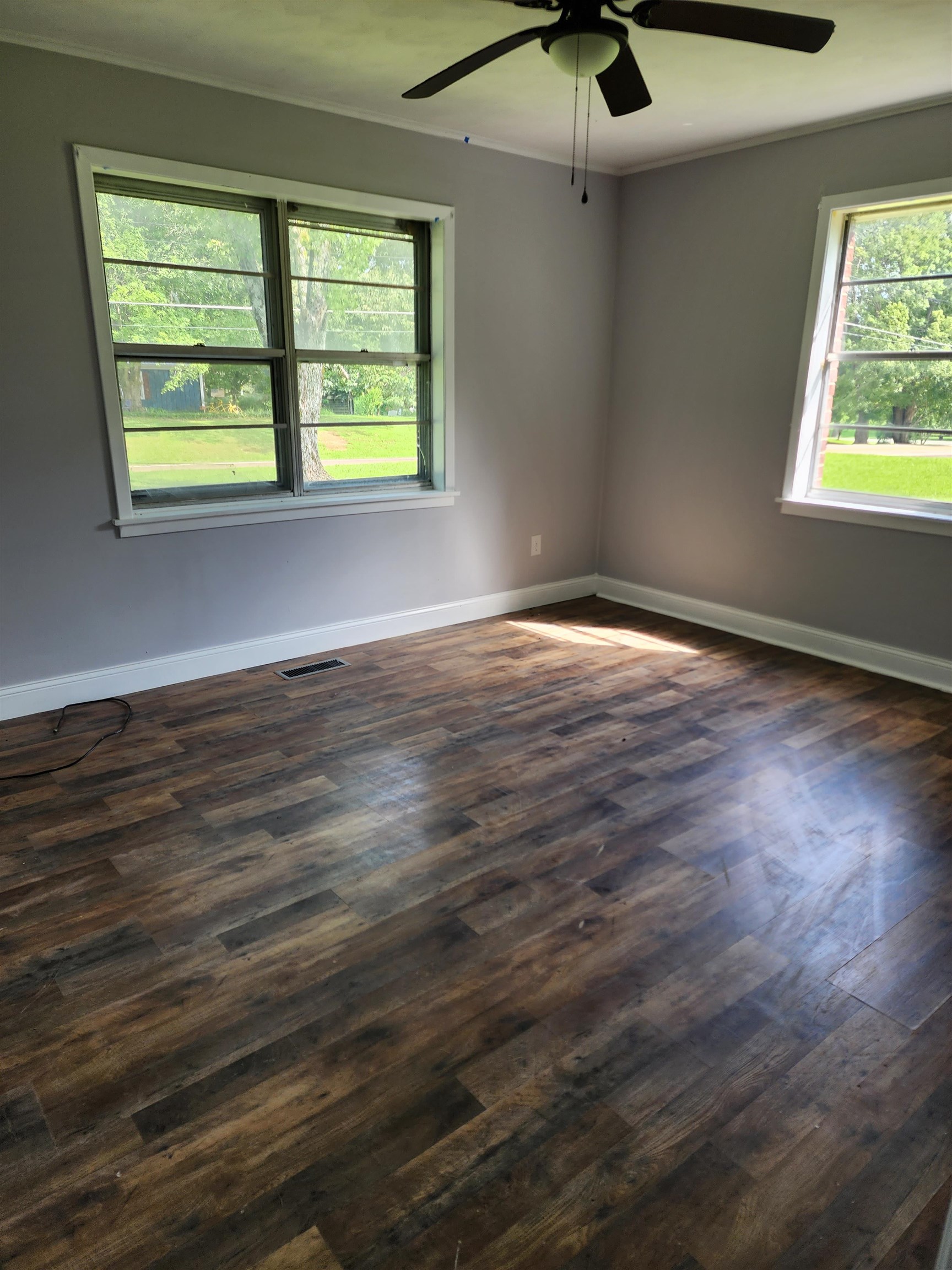 6673 Highway 209 Ripley, TN 38063 - Photo 5 of 13 an empty room with wooden floor and windows