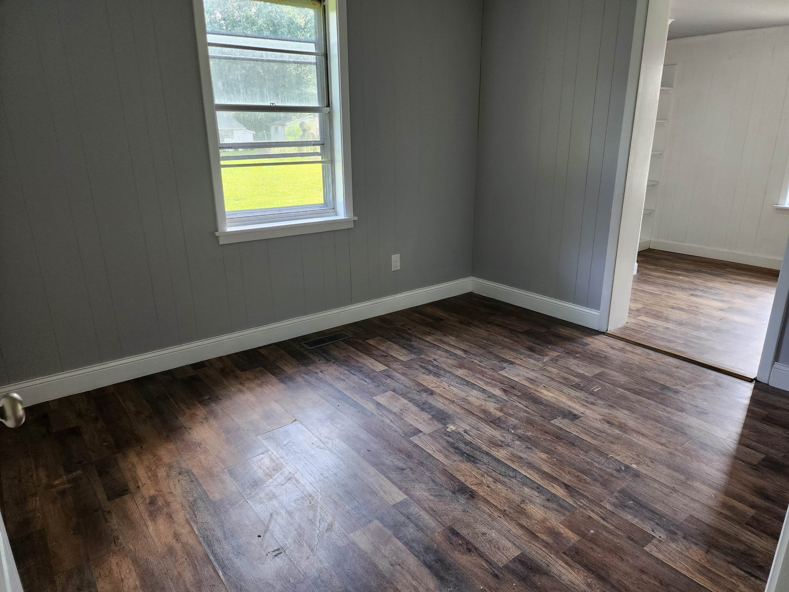 6673 Highway 209 Ripley, TN 38063 - Photo 8 of 13 a view of an empty room with wooden floor and a window