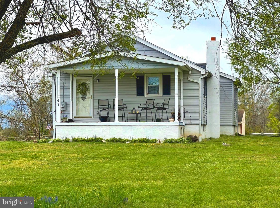 a front view of a house with a garden and yard