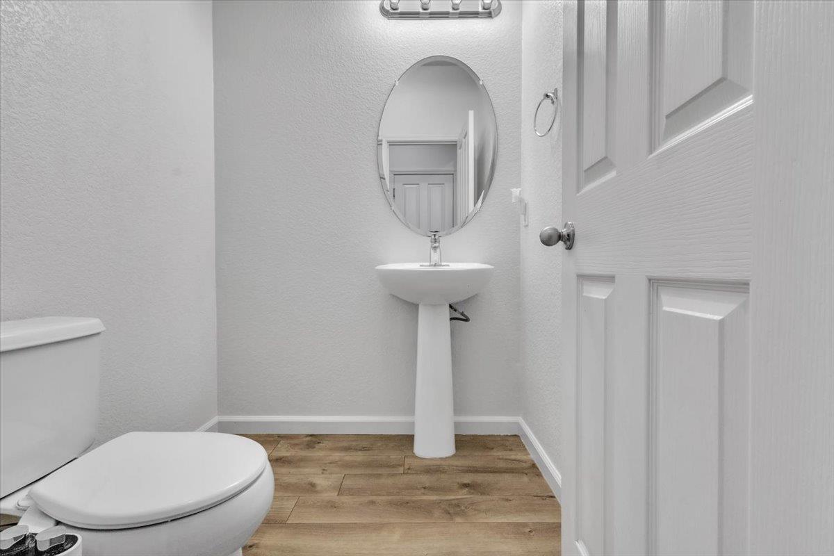 2608 Greenleaf Street Manteca, CA 95337 - Photo 19 of 65 a bathroom with a toilet a sink and mirror