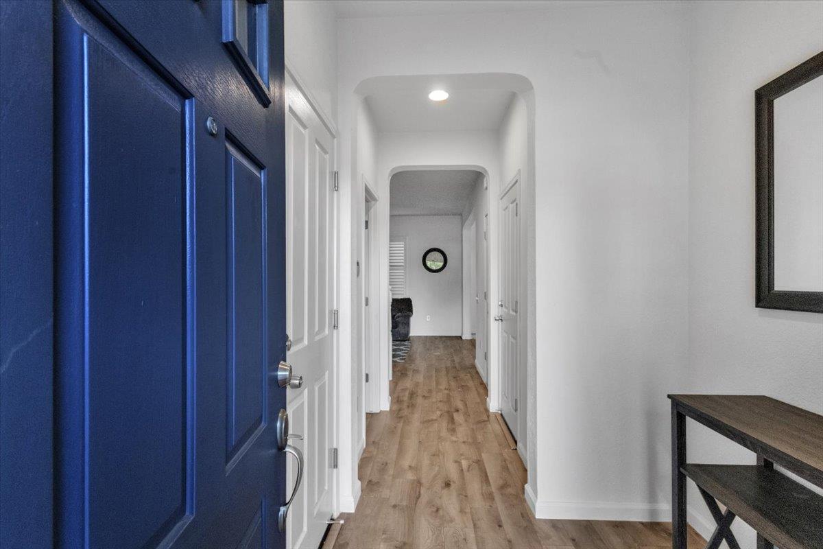 2608 Greenleaf Street Manteca, CA 95337 - Photo 2 of 65 a view of a hallway with wooden floor and closet area