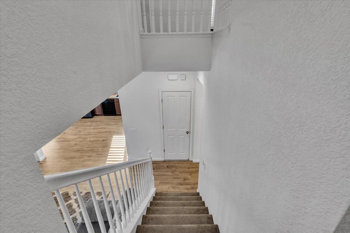 2608 Greenleaf Street Manteca, CA 95337 - Photo 24 of 65 a view of a hallway with wooden floor and staircase