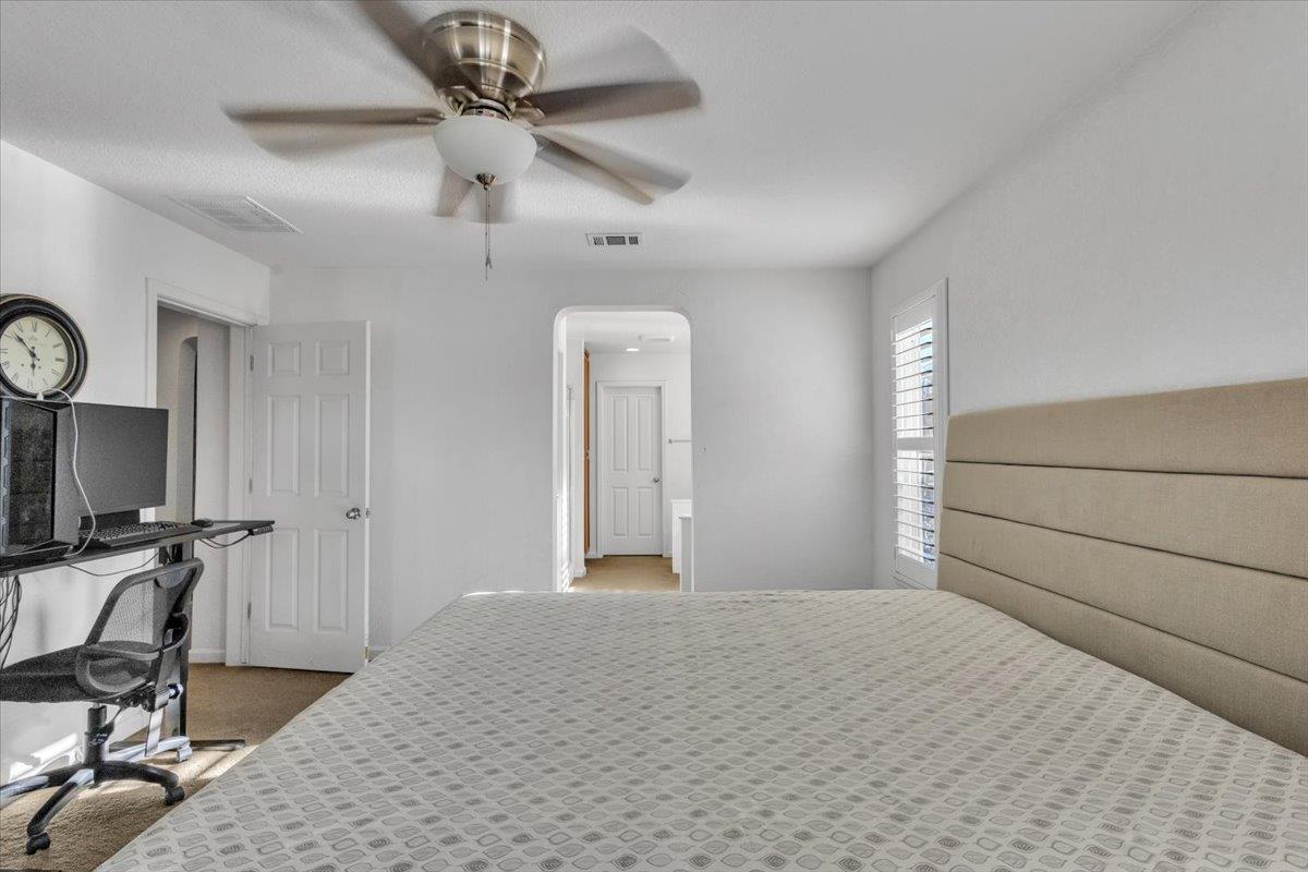 2608 Greenleaf Street Manteca, CA 95337 - Photo 27 of 65 a bedroom with a bed a desk and chair