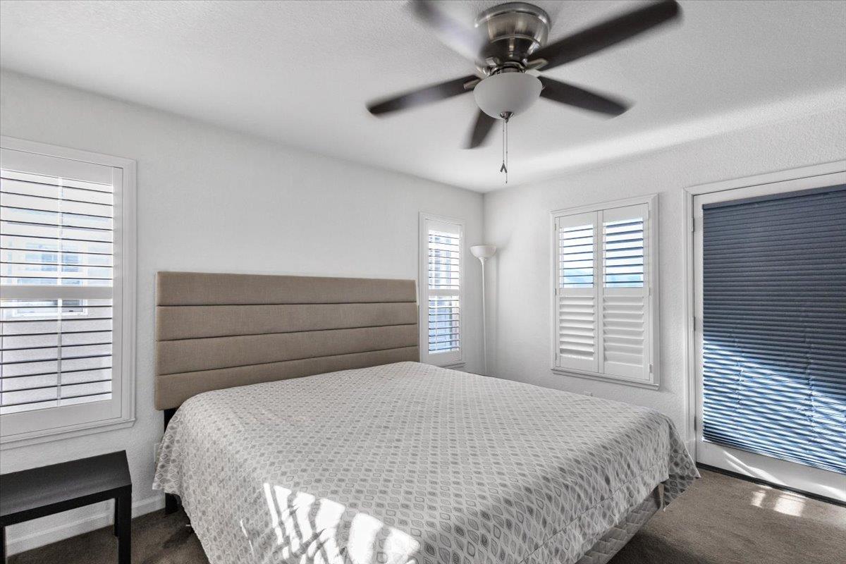2608 Greenleaf Street Manteca, CA 95337 - Photo 28 of 65 a bedroom with a bed and a ceiling fan
