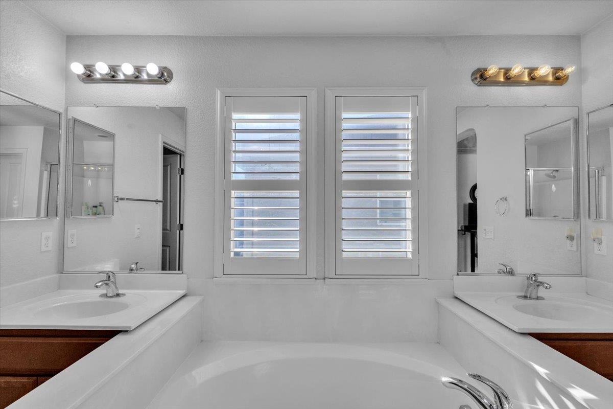 2608 Greenleaf Street Manteca, CA 95337 - Photo 31 of 65 a bathroom with a tub a sink and a window