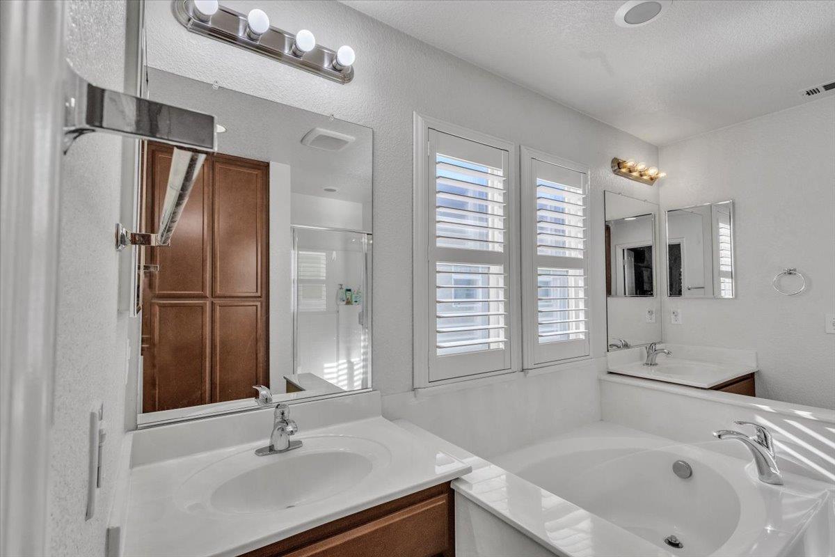 2608 Greenleaf Street Manteca, CA 95337 - Photo 32 of 65 a bathroom with a sink double vanity and a bathtub