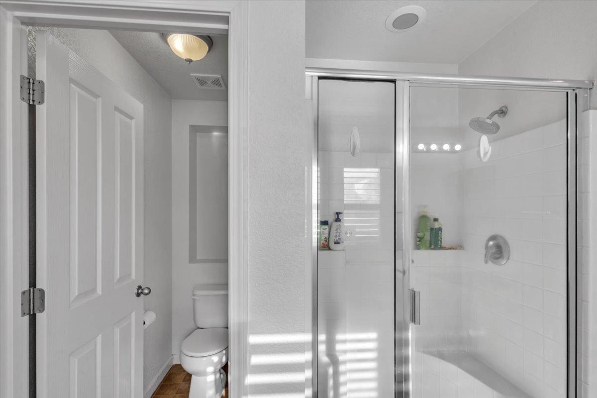 2608 Greenleaf Street Manteca, CA 95337 - Photo 35 of 65 a bathroom with a glass shower door