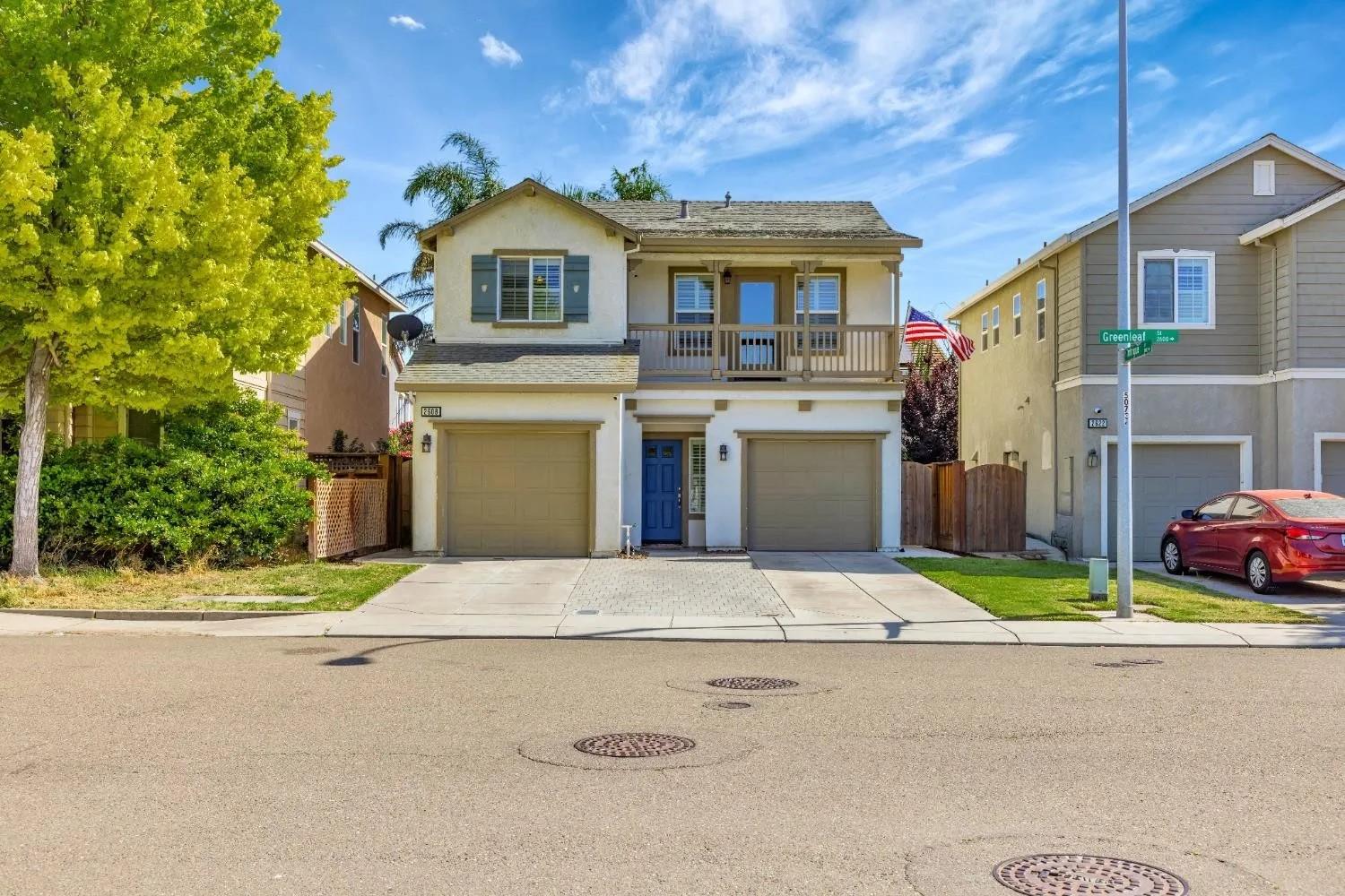 2608 Greenleaf Street Manteca, CA 95337 - Photo 4 of 65 a front view of a house with a yard and garage