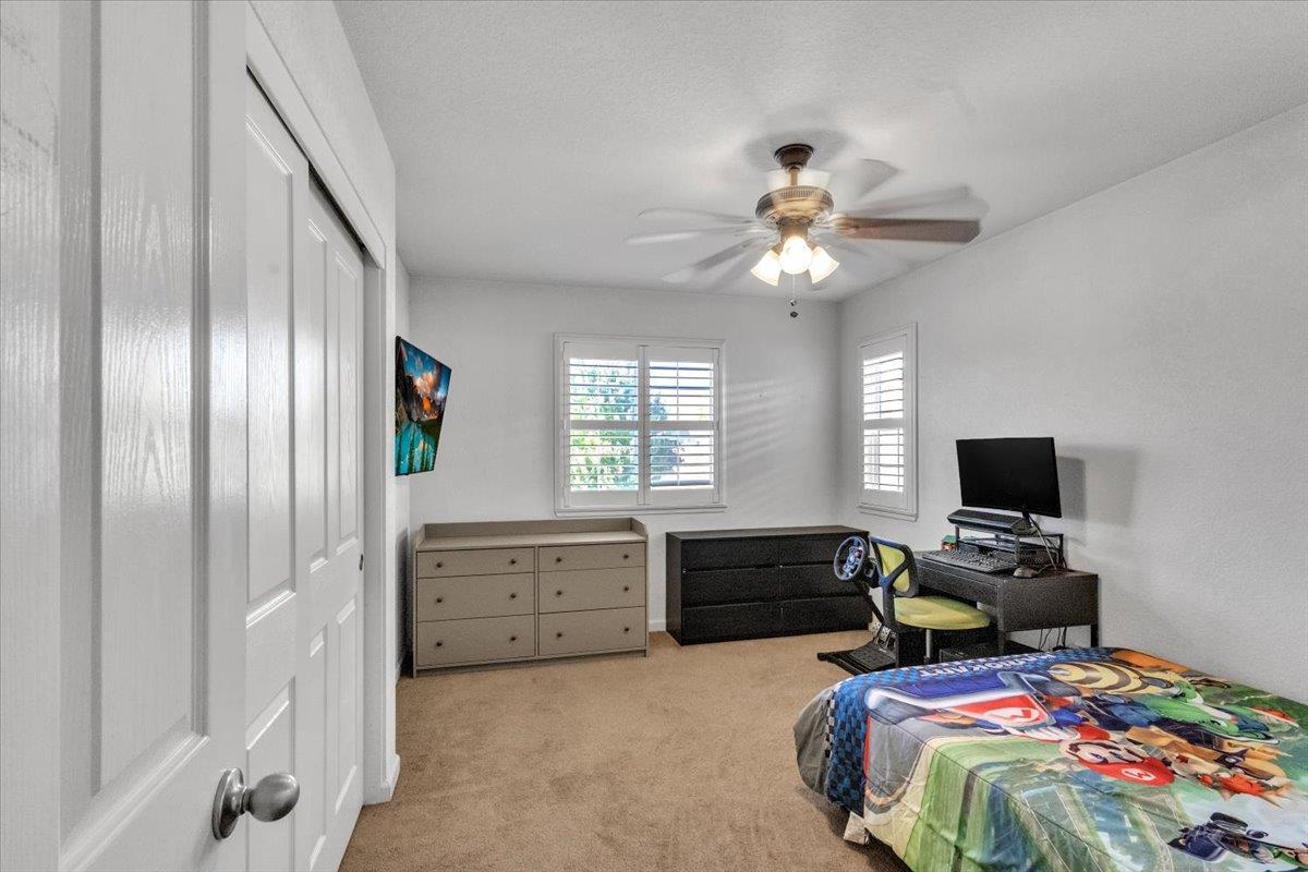 2608 Greenleaf Street Manteca, CA 95337 - Photo 45 of 65 a bedroom with a bed and a chandelier